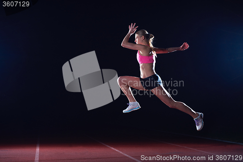 Image of Athletic woman running on track