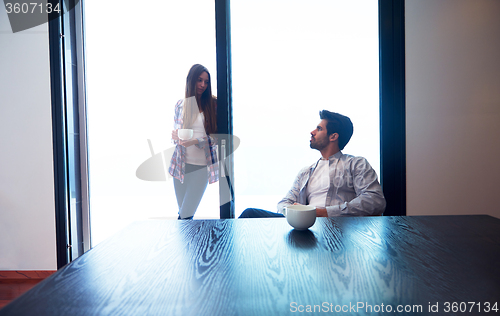 Image of relaxet young couple drink first morning coffee