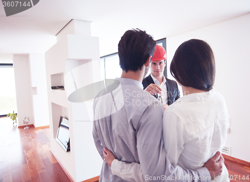 Image of couple buying new home with real estate agent