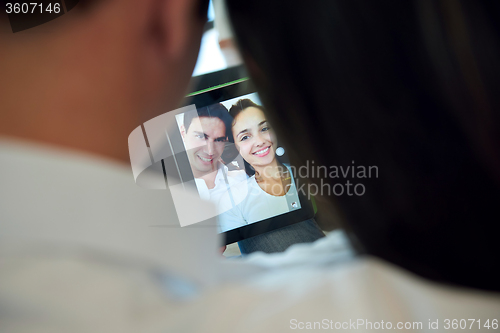 Image of couple at modern home using tablet computer