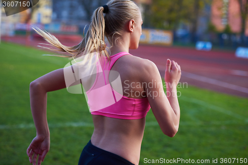 Image of athlete woman group  running on athletics race track