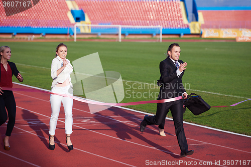 Image of business people running on racing track