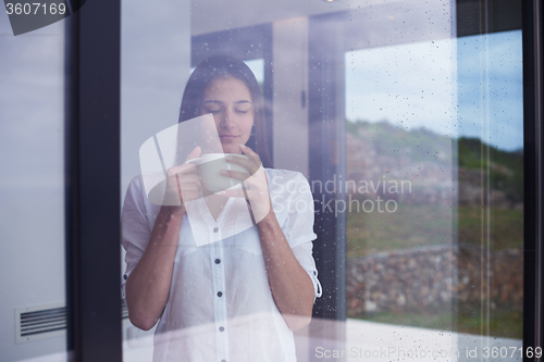 Image of beautiful young woman drink first morning coffee