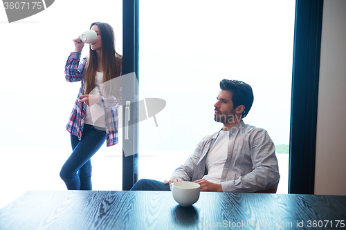 Image of relaxet young couple drink first morning coffee