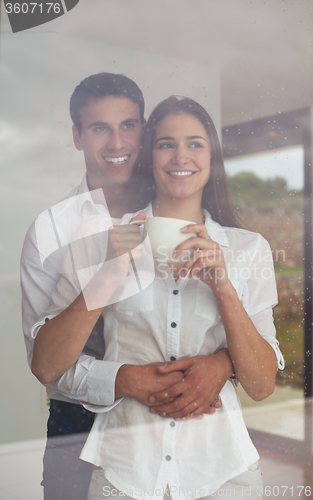 Image of relaxet young couple drink first morning coffee