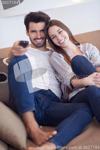 Image of young couple watching tv at home