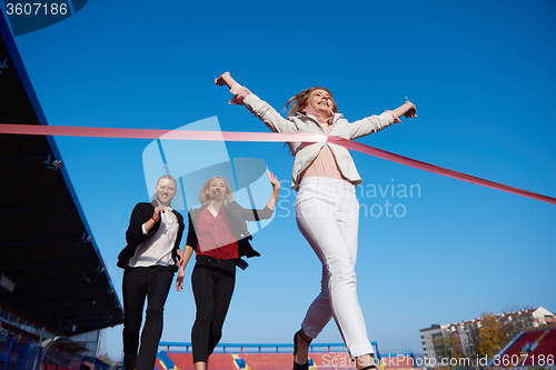 Image of business people running on racing track