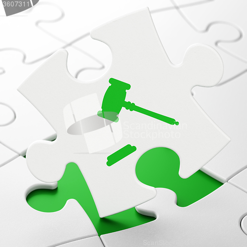 Image of Law concept: Gavel on puzzle background