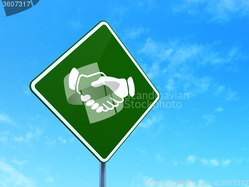 Image of Political concept: Handshake on road sign background