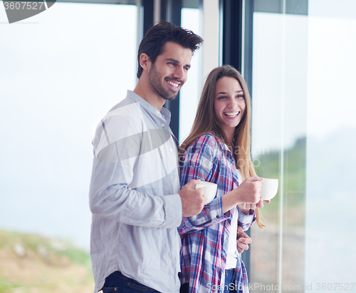 Image of relaxet young couple drink first morning coffee