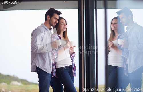 Image of relaxet young couple drink first morning coffee