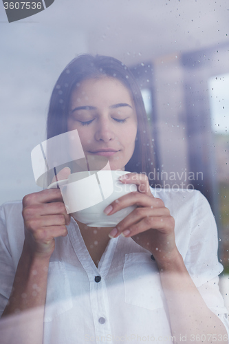 Image of beautiful young woman drink first morning coffee