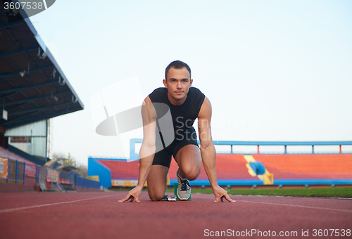 Image of pixelated design of woman  sprinter leaving starting blocks