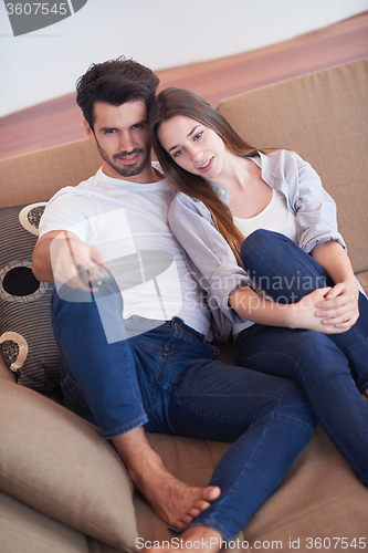 Image of young couple watching tv at home