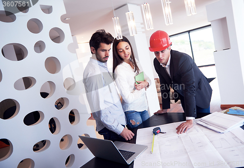 Image of couple buying new home with real estate agent