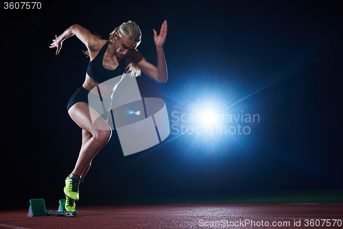 Image of pixelated design of woman  sprinter leaving starting blocks