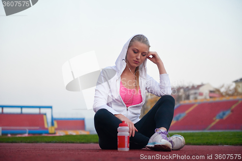 Image of sporty woman on athletic race track
