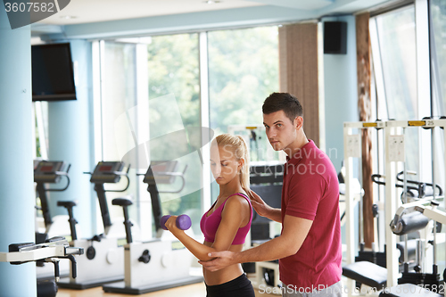 Image of young sporty woman with trainer exercise weights lifting