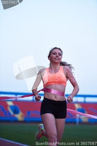 Image of sporty woman on athletic race track