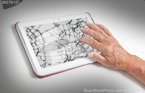 Image of Senior lady with tablet, cracked screen