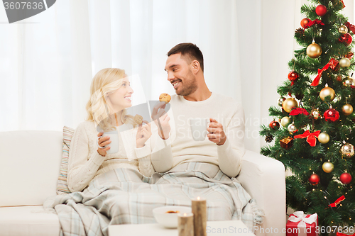 Image of happy couple at home with christmas tree