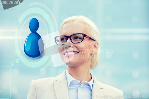 Image of young smiling businesswoman in eyeglasses outdoors