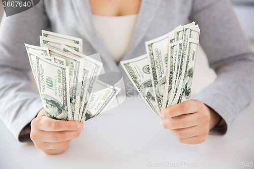 Image of close up of woman hands holding us dollar money