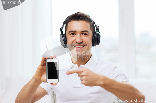 Image of happy man with smartphone and headphones