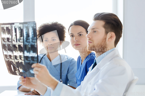 Image of group of doctors looking to x-ray at hospital