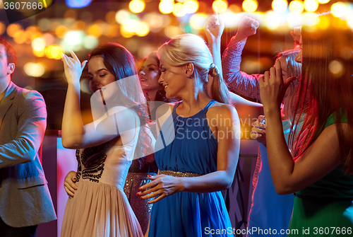 Image of group of happy friends dancing in night club