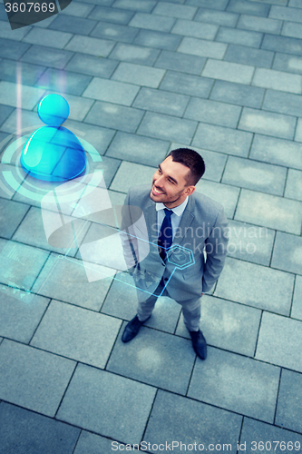 Image of young smiling businessman outdoors from top