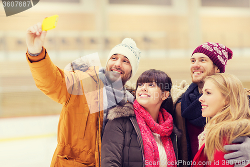 Image of happy friends taking selfie on skating rink