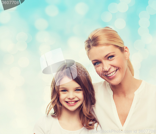 Image of smiling mother and little girl