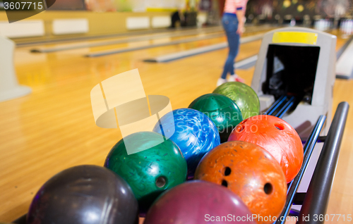 Image of balls on ball return system in bowling club