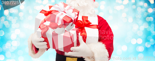 Image of close up of santa claus with gift boxes