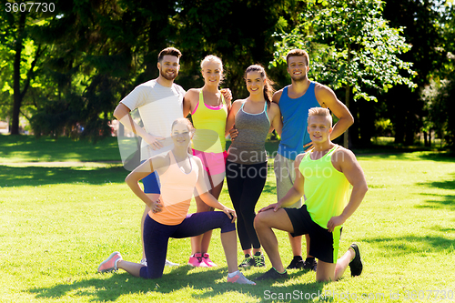 Image of group of happy friends or sportsmen outdoors