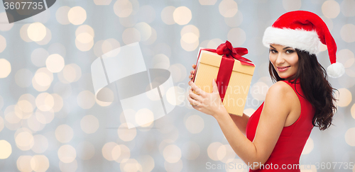 Image of beautiful sexy woman in santa hat with gift box