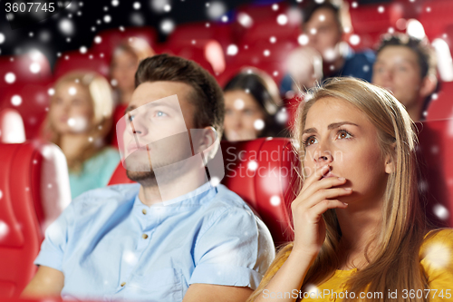 Image of friends or couple watching horror movie in theater