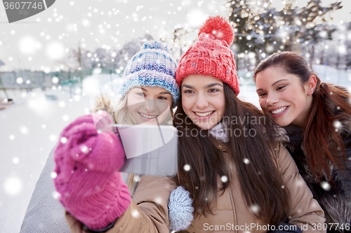 Image of happy teenage girls taking selfie with smartphone