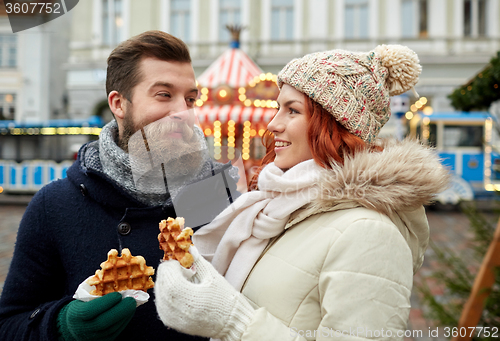 Image of happy couple walking in old town