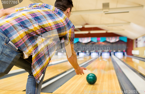 Image of close up of man throwing ball in bowling club