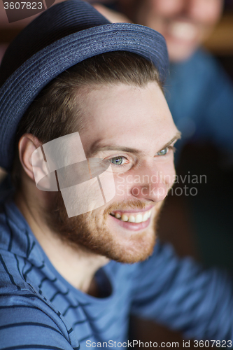 Image of happy young man in hipster hat