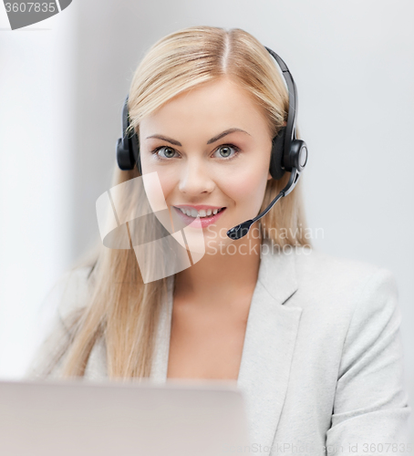 Image of friendly female helpline operator with laptop