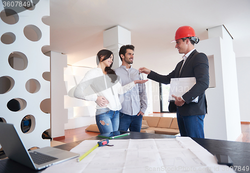 Image of couple buying new home with real estate agent