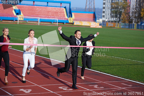 Image of business people running on racing track