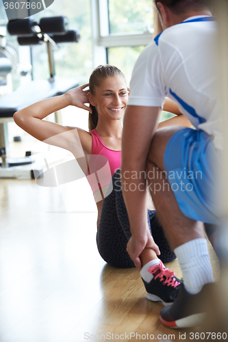 Image of young sporty woman with trainer exercise in fitness gym