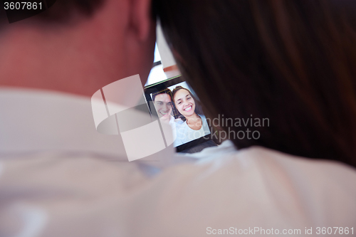 Image of couple at modern home using tablet computer