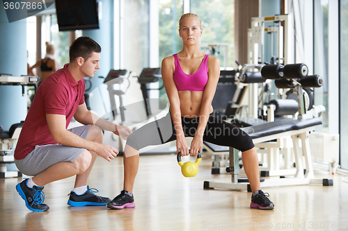 Image of young sporty woman with trainer exercise weights lifting