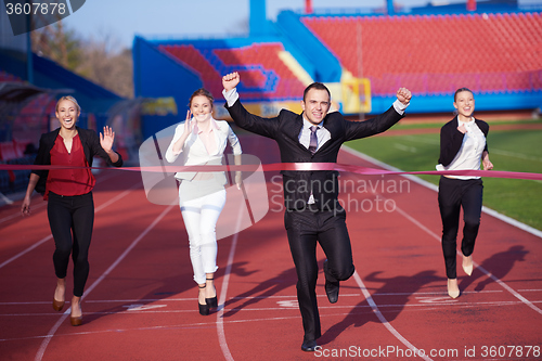 Image of business people running on racing track