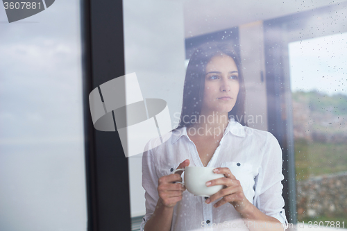 Image of beautiful young woman drink first morning coffee
